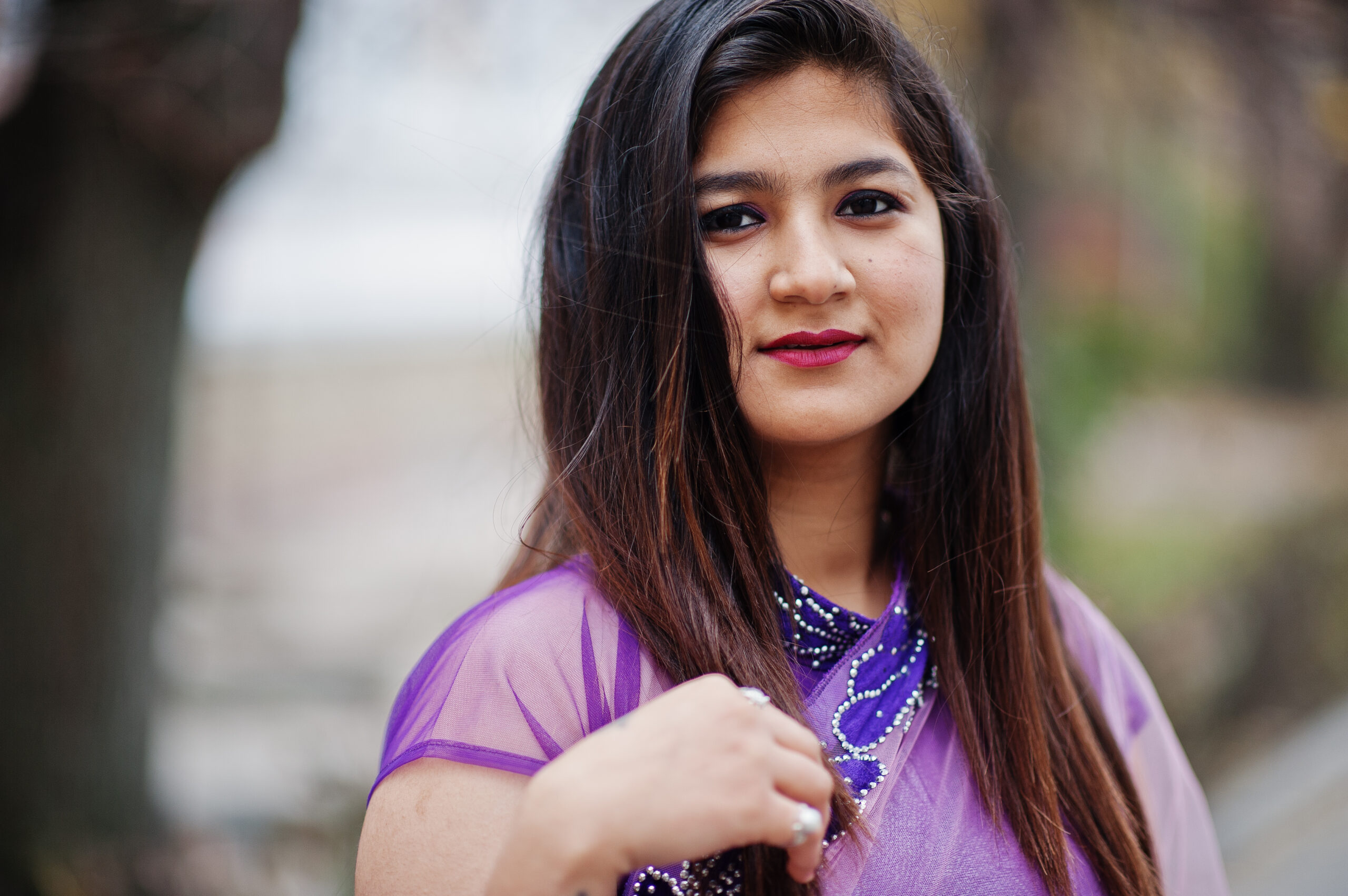 close up portrait of indian hindu girl at traditional violet sar